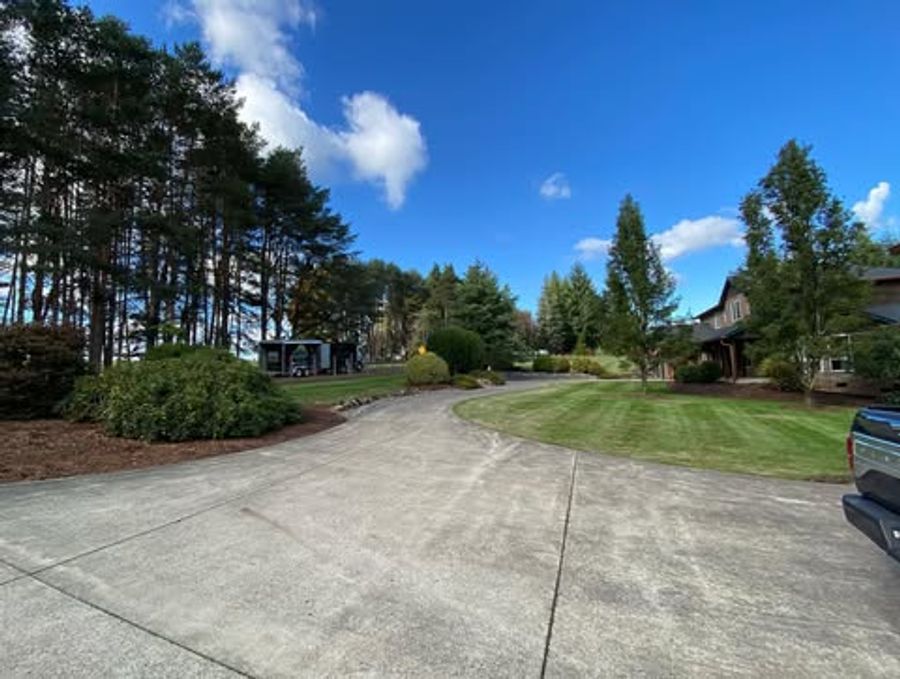 Large property with wide green lawn and A.L. Landscape Management truck